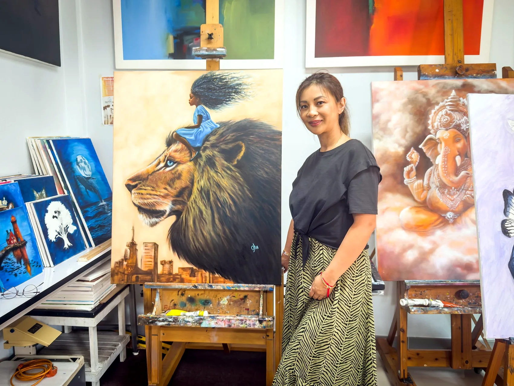 Adult student presenting a large lion painting