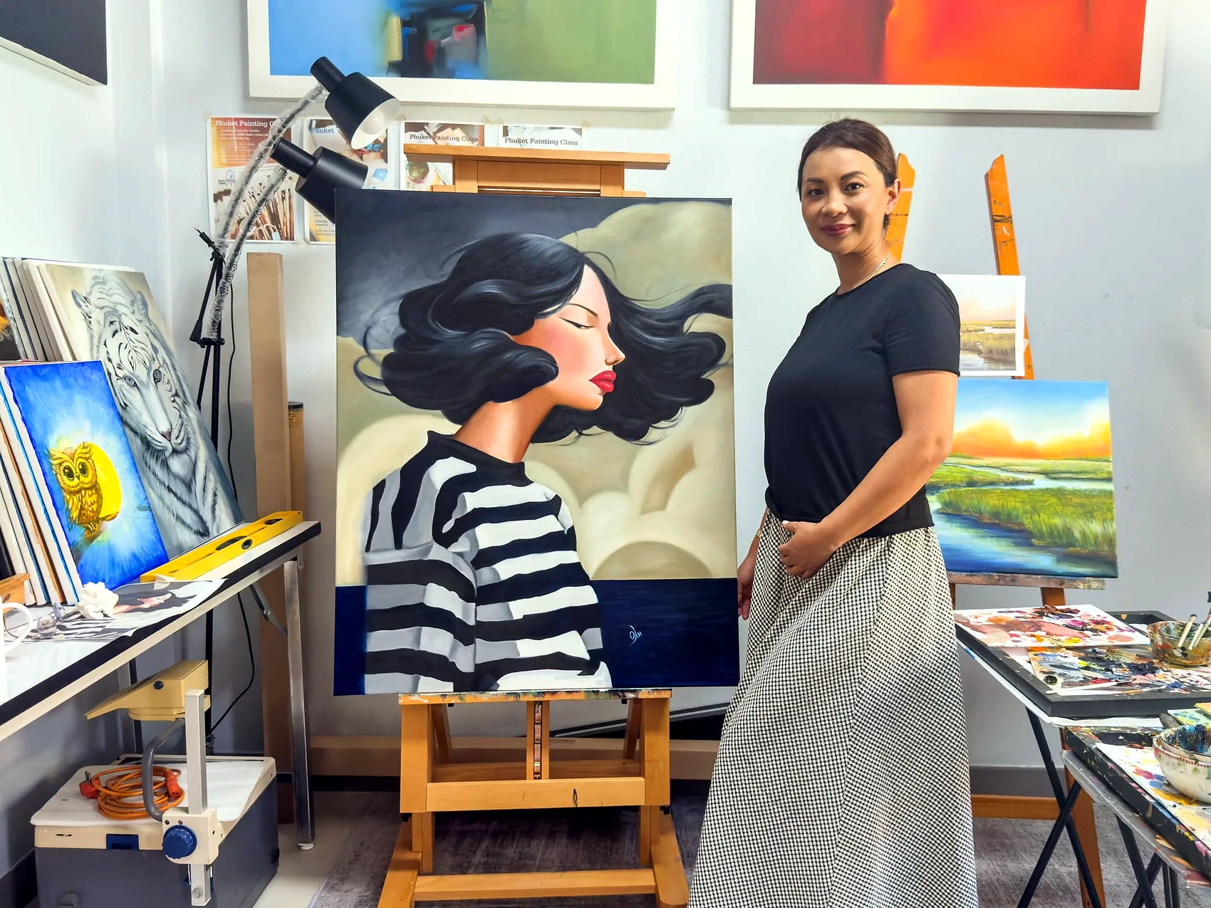 Adult student with a large stylized portrait painting