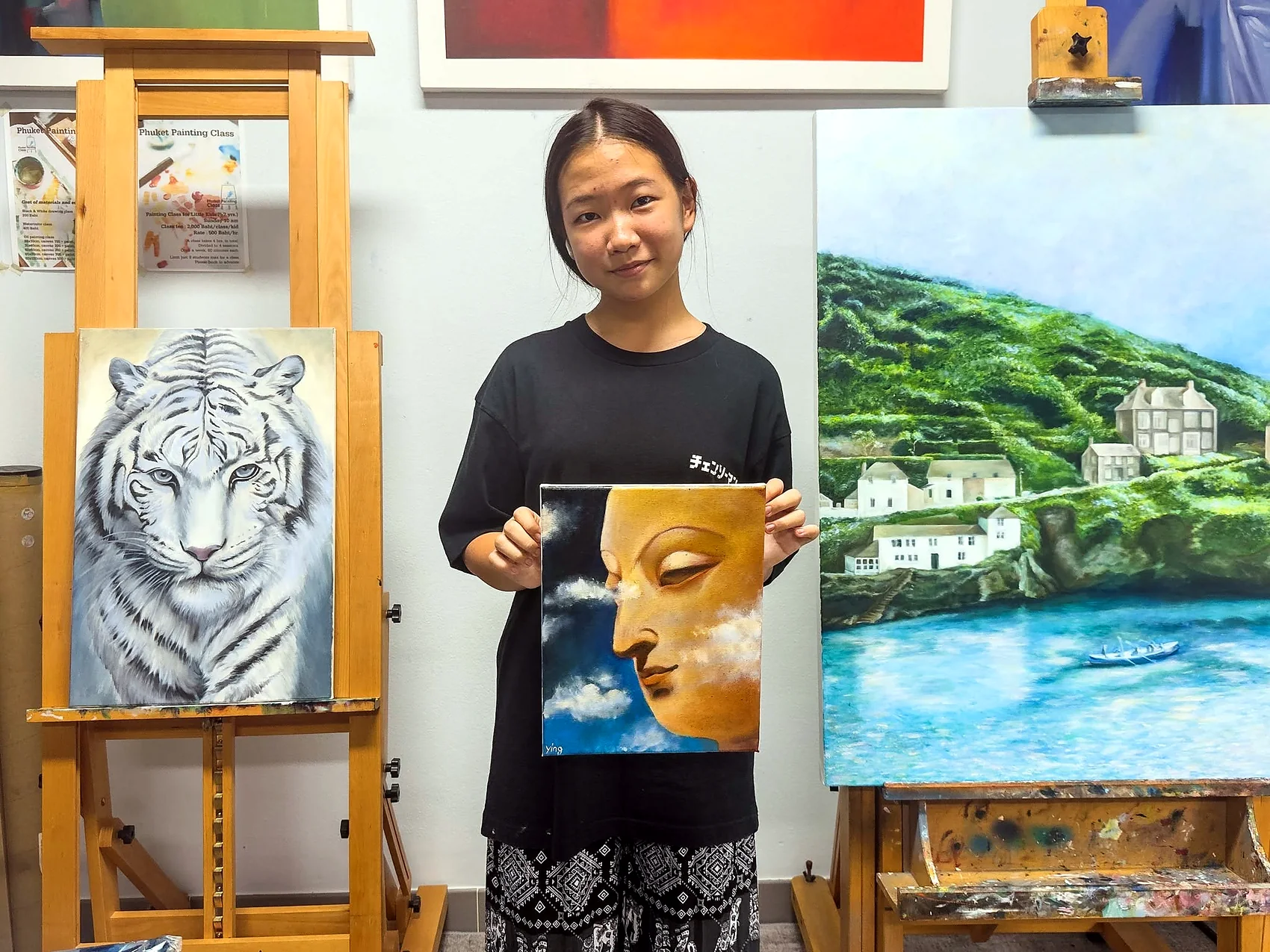 Teen student presenting paintings in the studio